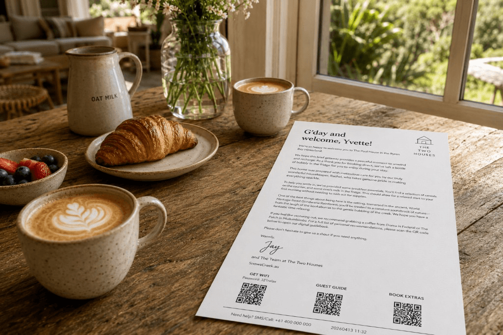 Breakfast on a table with coffee, flowers, and a welcome note — a thoughtful arrival at a vacation rental.
